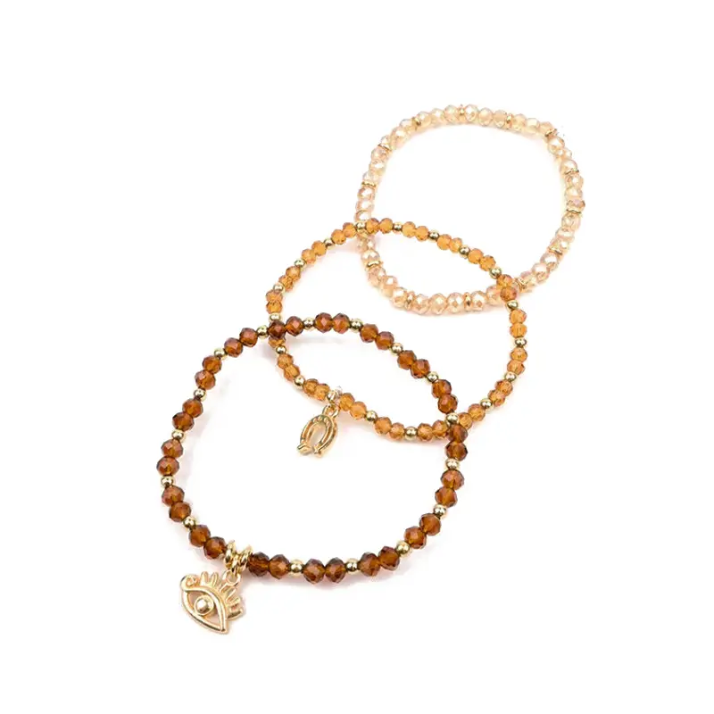 Set Tres Pulseras Elasticas Beige con Dijes Dorados