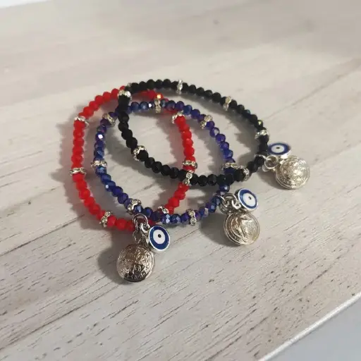 Pulsera Elastica con Dije Ojo Turco y San Benito Colores Surtidos 