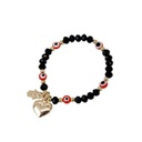 Pulsera Elastica Negra con Dijes Dorados de Corazon y Mano de Fatima con Ojos Turcos